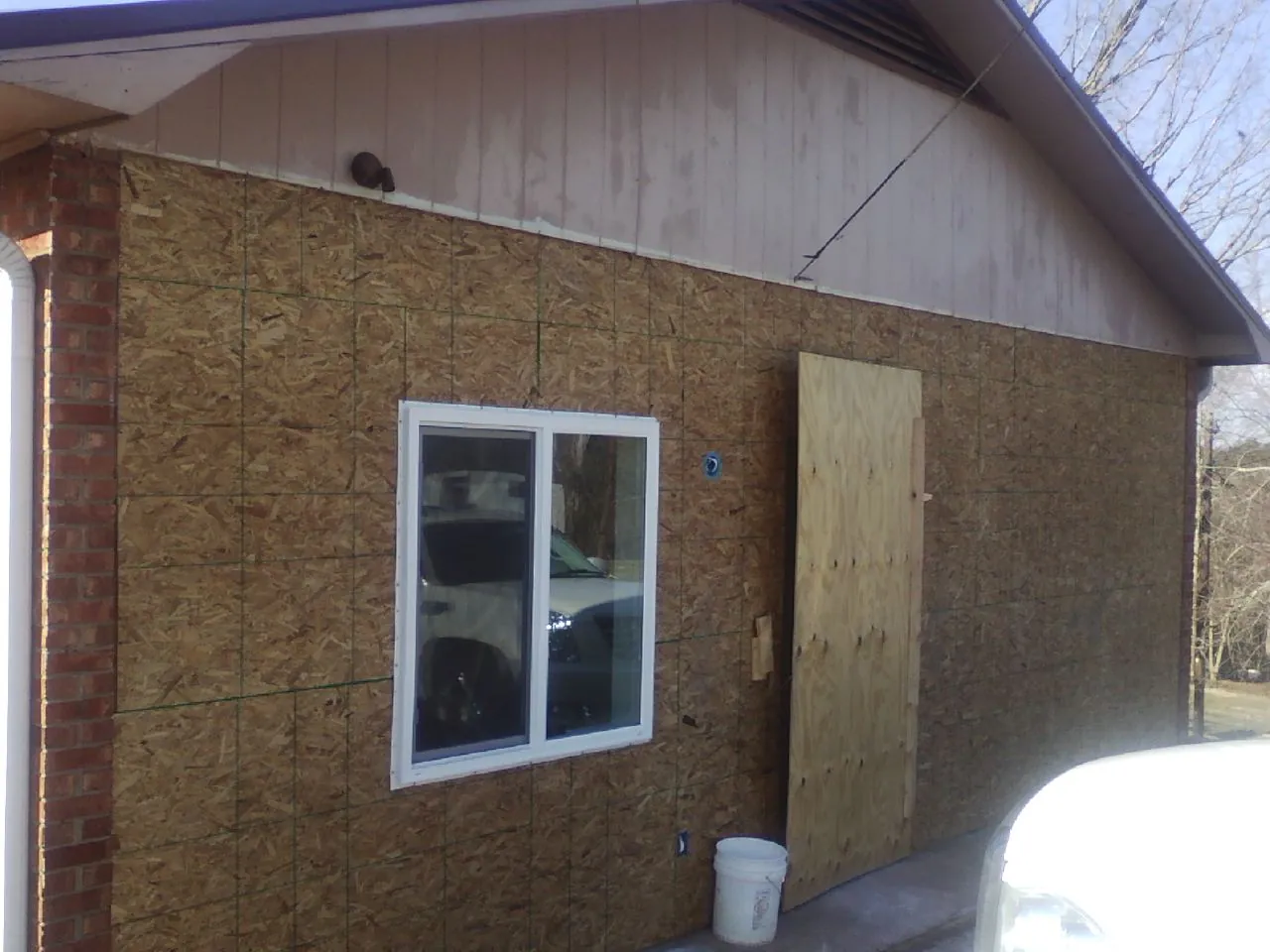 OSB sheathing on a garage addition wall before siding in Polkville