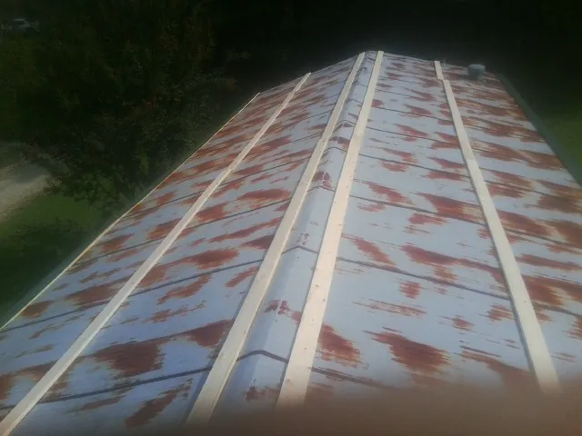 Rusted metal roof panels with new wood purlins before replacement — Storm Damage Roof Repair in Polkville by Roofing Brothers