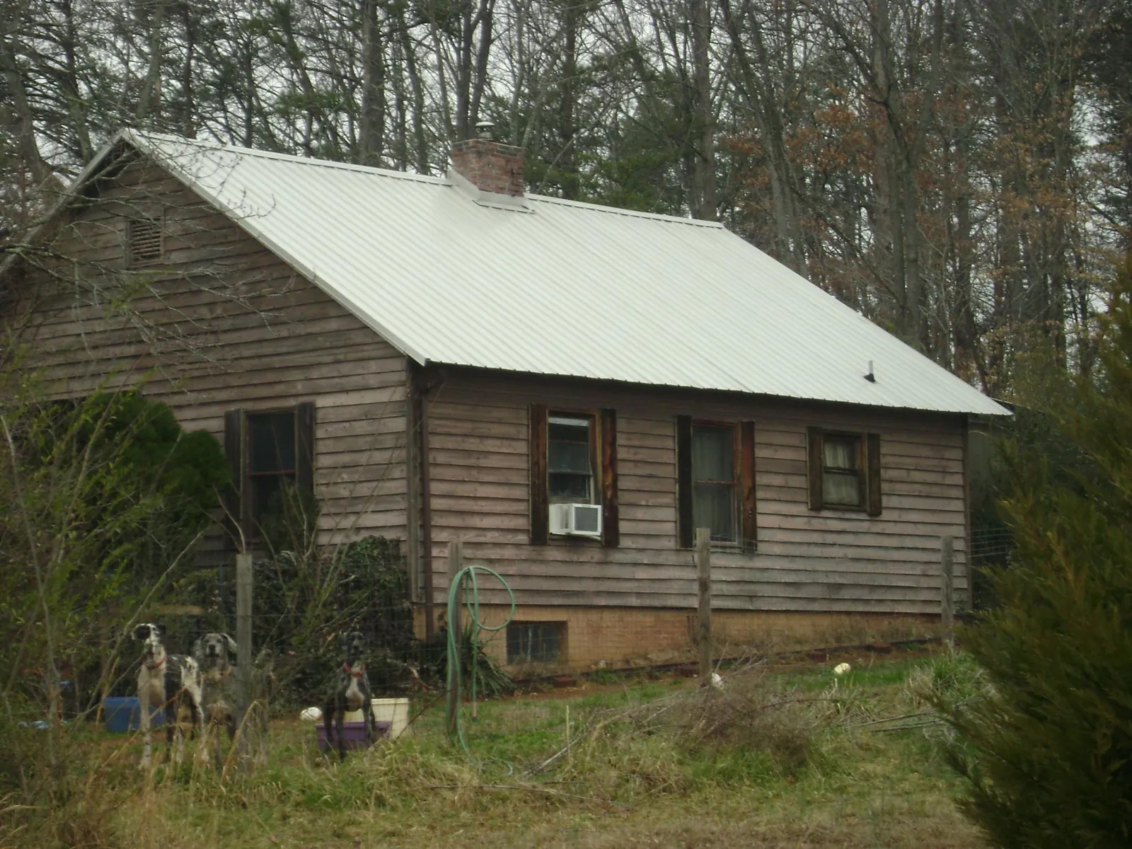White metal roof on an old wood sided farmhouse, from a Metal Roof Installation job in Polkville